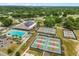 Beautiful aerial view of the community pool and pickleball courts surrounded by lush greenery at 9846 Sw 106Th Ct Ocala, F, Ocala, FL 34481