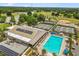Aerial view of the community pool and tennis courts, baseball field, and solar panels on the roof at 9846 Sw 106Th Ct Ocala, F, Ocala, FL 34481