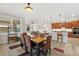 Dining area featuring an ornate chandelier, large windows, and access to kitchen and living areas at 9846 Sw 106Th Ct Ocala, F, Ocala, FL 34481