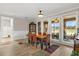 Bright dining room features tile flooring, a patterned rug, and large windows overlooking the backyard at 9846 Sw 106Th Ct Ocala, F, Ocala, FL 34481