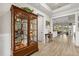 Inviting entryway featuring wood-look tile floors, a decorative cabinet, and a view into the dining area at 9846 Sw 106Th Ct Ocala, F, Ocala, FL 34481