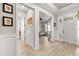 Bright foyer featuring wood-look tile floors, white wainscoting, and an open entryway to the rest of the home at 9846 Sw 106Th Ct Ocala, F, Ocala, FL 34481