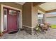 Inviting front porch with stylish door, stone accents, and comfortable seating area for relaxing outdoors at 9846 Sw 106Th Ct Ocala, F, Ocala, FL 34481