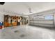 Spacious garage with overhead door and shelving, offering ample storage space and organization at 9846 Sw 106Th Ct Ocala, F, Ocala, FL 34481