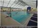 Bright indoor lap pool with skylights, offering a year-round aquatic fitness option for residents at 9846 Sw 106Th Ct Ocala, F, Ocala, FL 34481