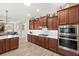 Modern kitchen featuring stainless steel appliances, tile backsplash and wood cabinets at 9846 Sw 106Th Ct Ocala, F, Ocala, FL 34481