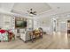 Inviting living room featuring a large built-in entertainment center and tray ceilings at 9846 Sw 106Th Ct Ocala, F, Ocala, FL 34481