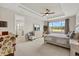 Spacious bedroom with tray ceilings, a large window overlooking the landscaped yard, and an en suite bathroom at 9846 Sw 106Th Ct Ocala, F, Ocala, FL 34481