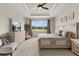 Spacious bedroom with trey ceilings, a large window overlooking the landscaped yard, and neutral walls at 9846 Sw 106Th Ct Ocala, F, Ocala, FL 34481