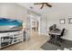 Well-lit home office with desk, ceiling fan, and entertainment center, perfect for remote work or study at 9846 Sw 106Th Ct Ocala, F, Ocala, FL 34481