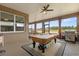 Covered patio featuring a pool table, grill, and views of the backyard and horizon at 9846 Sw 106Th Ct Ocala, F, Ocala, FL 34481