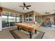 Covered patio featuring a pool table, ceiling fans, and an outdoor dining set at 9846 Sw 106Th Ct Ocala, F, Ocala, FL 34481