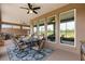 Covered patio with outdoor seating, a pool table, and scenic views of the backyard at 9846 Sw 106Th Ct Ocala, F, Ocala, FL 34481