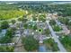 High angle showing a home in a tree filled neighborhood with a pool in the backyard at 10739 Lake Ralph Dr, Clermont, FL 34711