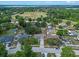 Aerial view of a home in a neighborhood, showcasing the garden, shed and pool at 10739 Lake Ralph Dr, Clermont, FL 34711