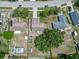 Aerial view of home with a large backyard with a garden, patio set, and screened-in pool at 10739 Lake Ralph Dr, Clermont, FL 34711