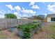 Vegetable garden bed in a sunny backyard next to a wooden fence at 10739 Lake Ralph Dr, Clermont, FL 34711