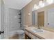 Functional bathroom featuring a shower-tub combo, vanity with sink, and ample lighting at 10739 Lake Ralph Dr, Clermont, FL 34711