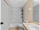 Functional bathroom featuring a shower-tub combo, vanity with sink, and ample lighting at 10739 Lake Ralph Dr, Clermont, FL 34711