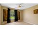 Bedroom featuring a large window with blackout curtains, a ceiling fan, and tile flooring at 10739 Lake Ralph Dr, Clermont, FL 34711