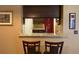 Dining area view through granite countertop and dark wood cabinets in kitchen at 10739 Lake Ralph Dr, Clermont, FL 34711