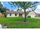 Attractive single-story home with a red door, green lawn, and an attached two-car garage at 10739 Lake Ralph Dr, Clermont, FL 34711