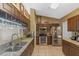 Modern kitchen with dark wood cabinets, granite countertops, stainless steel appliances, and tile flooring at 10739 Lake Ralph Dr, Clermont, FL 34711