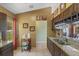 Updated kitchen with granite countertops, tile flooring, dark wood cabinets, and a view through to the dining area at 10739 Lake Ralph Dr, Clermont, FL 34711