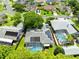 An aerial view of a well-landscaped home with solar panels and a screened-in pool at 10743 Fairhaven Way, Orlando, FL 32825