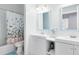 Bright bathroom with double sinks, a decorative butterfly curtain, and a toilet at 10743 Fairhaven Way, Orlando, FL 32825