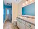 Tiled bathroom with a blue accent wall, mosaic tile countertops, and a shower at 10743 Fairhaven Way, Orlando, FL 32825