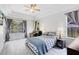 Serene main bedroom featuring ample natural light, hardwood floors, and stylish furniture at 10743 Fairhaven Way, Orlando, FL 32825