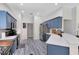 Bright kitchen with blue cabinets, stainless appliances, quartz countertops, and modern finishes at 10743 Fairhaven Way, Orlando, FL 32825