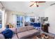 Open-concept living area showcasing hardwood flooring, and a sliding glass door with views of a screened patio and pool at 10743 Fairhaven Way, Orlando, FL 32825