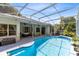 Sparkling pool surrounded by a screened-in patio and lush landscaping at 10743 Fairhaven Way, Orlando, FL 32825