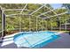 Enclosed in a screen, this refreshing pool features blue tile accents and offers a private backyard oasis at 10743 Fairhaven Way, Orlando, FL 32825