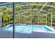 Enjoy the serenity of the screened-in pool with tranquil surroundings, perfect for relaxing and entertaining at 10743 Fairhaven Way, Orlando, FL 32825