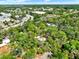 Aerial view showcases the neighborhood with houses surrounded by green trees, roads and commercial buildings at 109 Crown Oaks Way # 109, Longwood, FL 32779