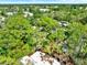 An aerial view shows the roof of the property amidst a landscape of verdant trees and vegetation at 109 Crown Oaks Way # 109, Longwood, FL 32779