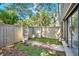 Fenced backyard features mature landscaping, and a gate to exterior walkways at 109 Crown Oaks Way # 109, Longwood, FL 32779