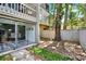 Private backyard features wood fence, slider to interior, and mature trees and landscaping at 109 Crown Oaks Way # 109, Longwood, FL 32779