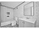 Updated bathroom boasts a shower-tub combo, subway tiles, and a modern vanity at 109 Crown Oaks Way # 109, Longwood, FL 32779