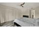 Bright bedroom features updated wood-look flooring, ample closet space, and a modern ceiling fan at 109 Crown Oaks Way # 109, Longwood, FL 32779