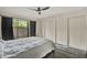 Well-lit bedroom with large windows, closet space, and modern ceiling fan at 109 Crown Oaks Way # 109, Longwood, FL 32779