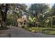 Charming entrance to a lush community with mature trees and a guard house at 109 Crown Oaks Way # 109, Longwood, FL 32779