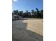 Spacious equestrian area with sandy ground, white fencing, and stable building at 109 Crown Oaks Way # 109, Longwood, FL 32779