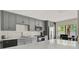 Updated kitchen with stainless steel appliances, gray cabinets and quartz countertops at 109 Crown Oaks Way # 109, Longwood, FL 32779
