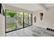 Enclosed patio area features sliding glass doors and views of a fenced green space at 109 Crown Oaks Way # 109, Longwood, FL 32779