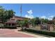 Inviting entrance to Lake Pineloch Village, showcasing lush landscaping and a charming guard house at 1252 Lake Willisara Cir # Ge, Orlando, FL 32806