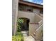 Inviting condo featuring a gated entrance, stucco walls, and stairs to the upper level at 1252 Lake Willisara Cir # Ge, Orlando, FL 32806